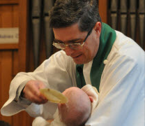 [Vicar performing a Baptism]